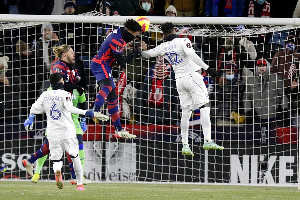 United States' Weston McKennie heads in a goal past Honduras' Rommel Quioto and Juan Delgado.
