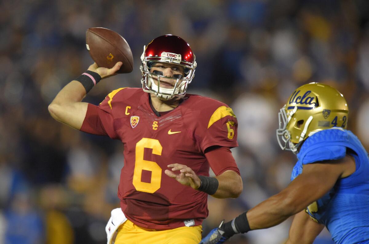 USC quarterback Cody Kessler passes under pressure from UCLA linebacker Kenny Young during a game at the Rose Bowl on Nov. 22.