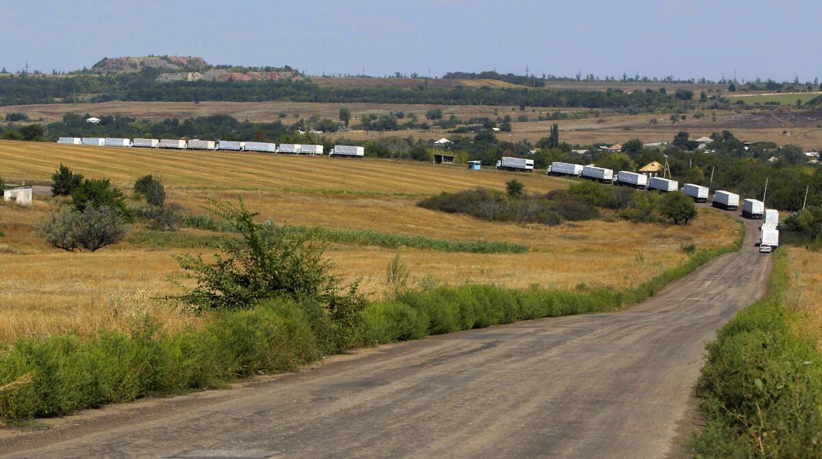The first trucks of a convoy purportedly carrying Russian aid head to Luhansk after crossing the border into eastern Ukraine on Aug. 22.