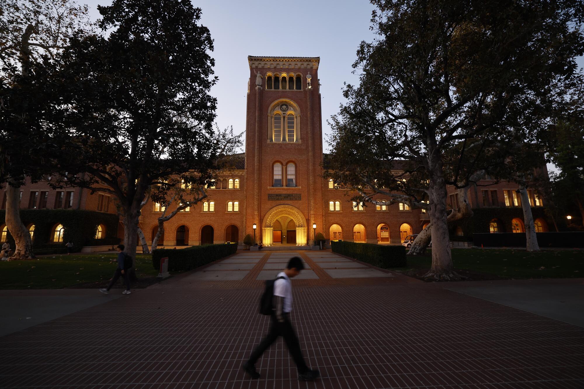 A student walks across the USC campus