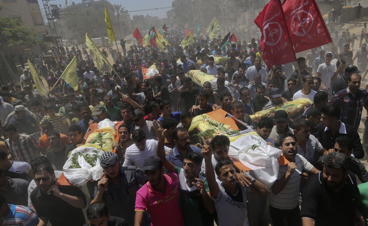 Palestinians carry the bodies of seven people killed in an Israeli strike at the Khan Yunis refugee camp in the southern Gaza Strip on July 9.