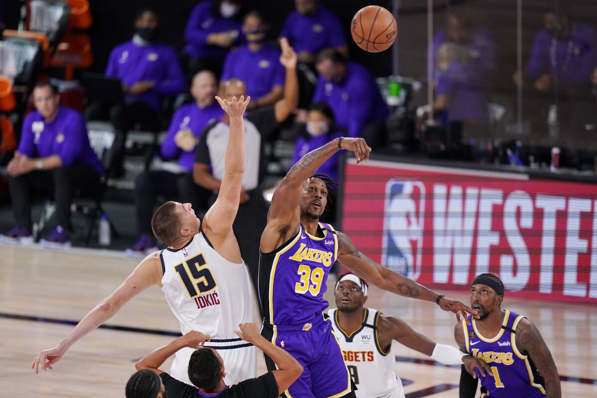 Lakers center Dwight Howard battles for the tip against Denver's Nikola Jokic to start Game 5.
