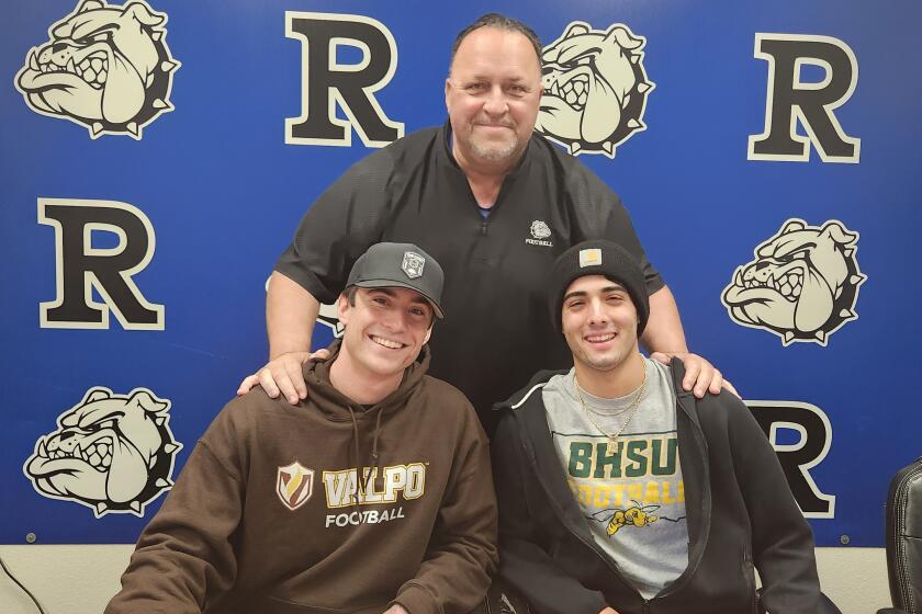 Kyle Patenaude (left) and Jamil Kassab (right) with Coach Damon Baldwin after signing on to their colleges on Feb. 7.