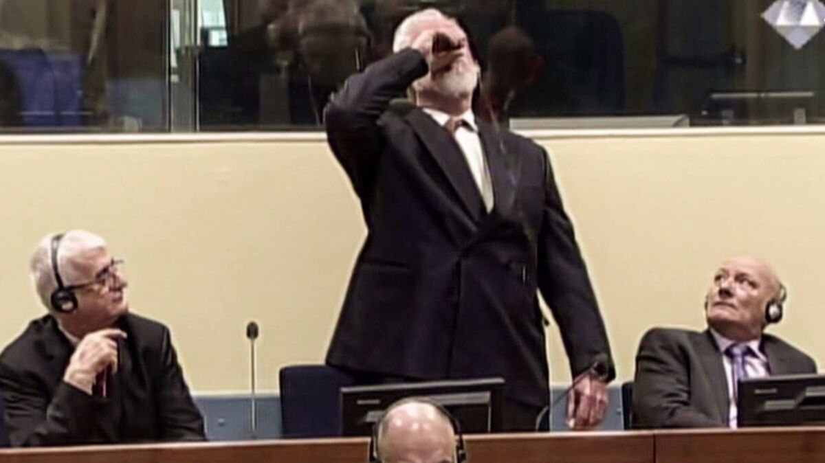 Former Croatian general Slobodan Praljak swallows what he said was poison after appeals judges at the U.N. war crimes court in the Hague upheld his 20-year jail term on Nov. 29.