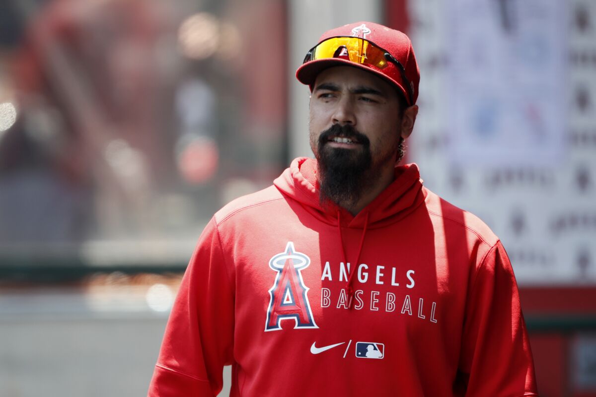 Angels' Anthony Rendon walks in the dugout before a game.
