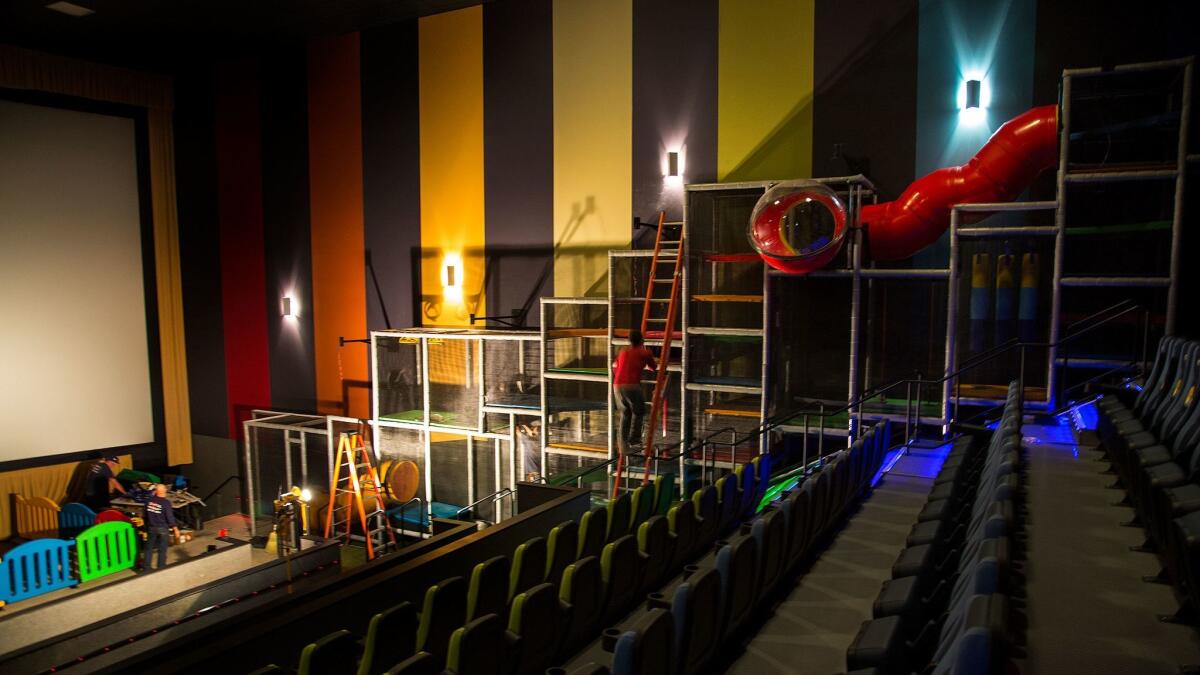 Construction workers finish a play structure inside the children's auditorium at Cinepolis USA's Pico Rivera multiplex.