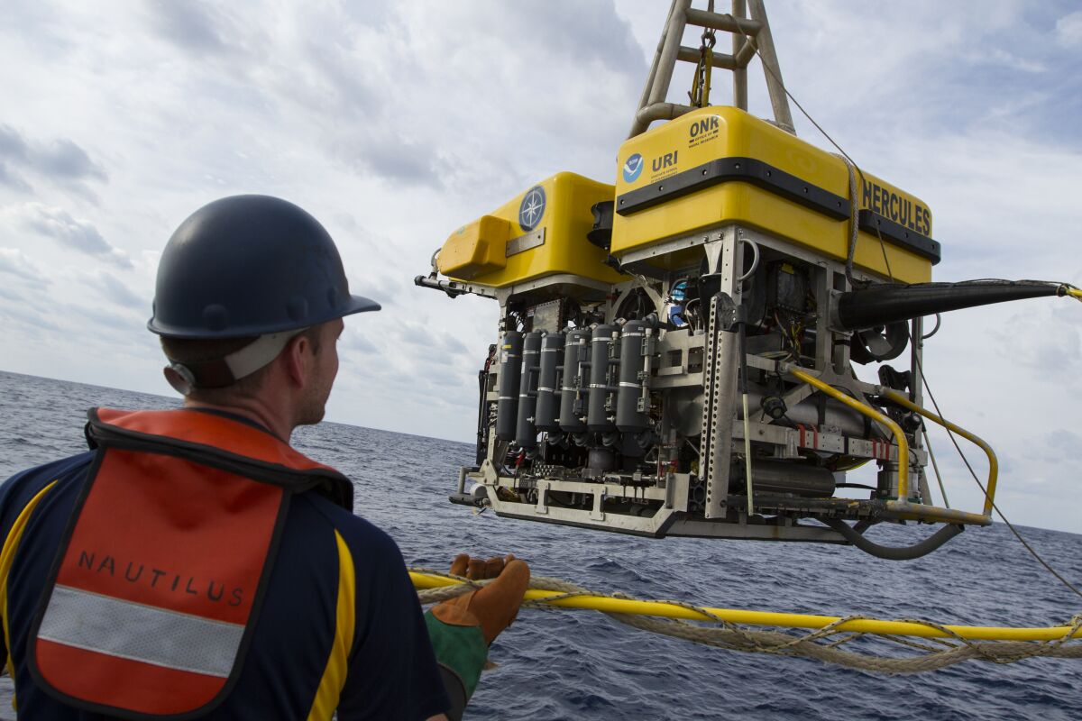 Scientists lower the ROV Hercules into the ocean to explore deep sea ridges and seamounts off Southern California