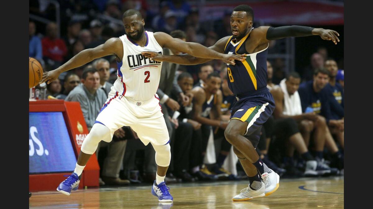 Clippers guard Raymond Felton loses control of his dribble while being defended by Jazz guard Shelvin Mack.