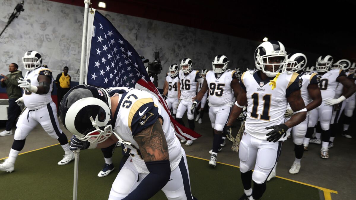 Defensive end Morgan Fox leads the Rams onto the field Sunday at home before they recorded their seventh win of the season against the Texans. Next up for the team is a trip to Minnesota to face the Vikings.
