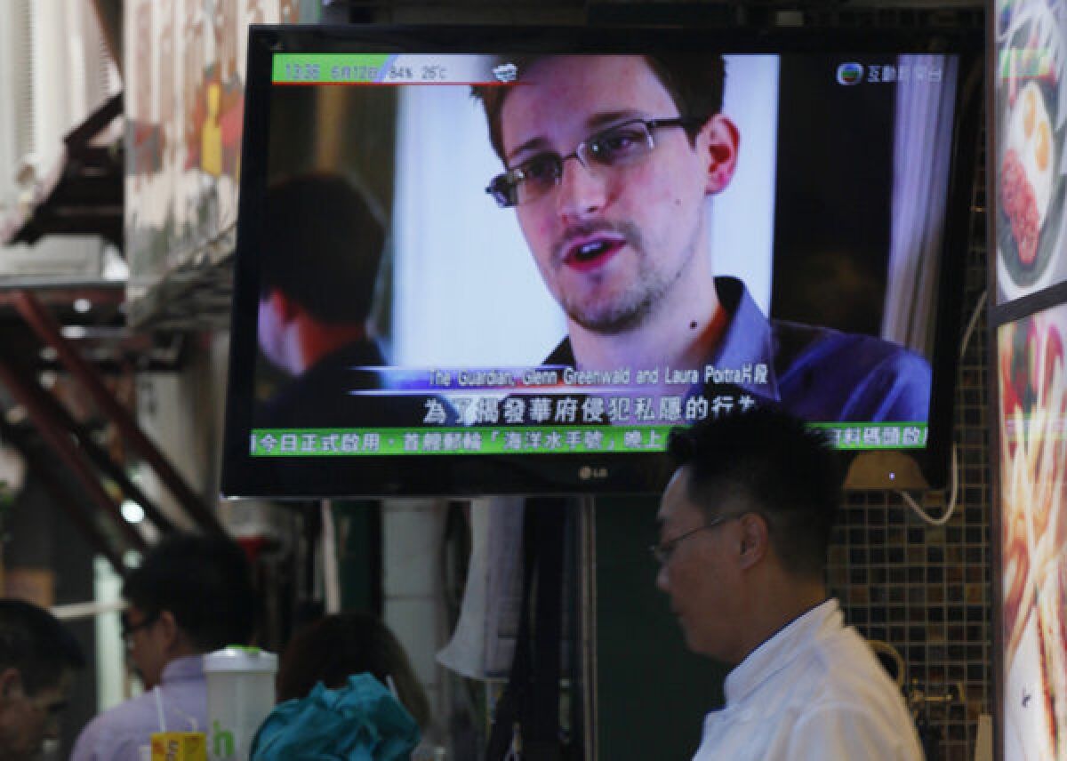 A TV screen shows news of Edward Snowden, who says he leaked top-secret U.S. documents about sweeping surveillance programs, at a restaurant in Hong Kong.