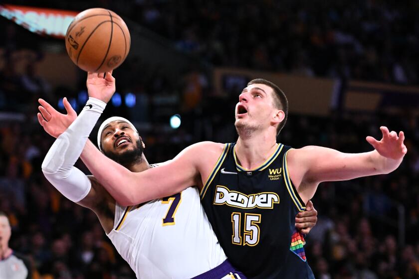 Los Angeles, California April 3, 2022- Lakers Carmelo Anthony and Nuggets Nikola Jokic battle for position in the fourth quarter at Crypto.com Arena Sunday. (Wally Skalij/Los Angeles Times)