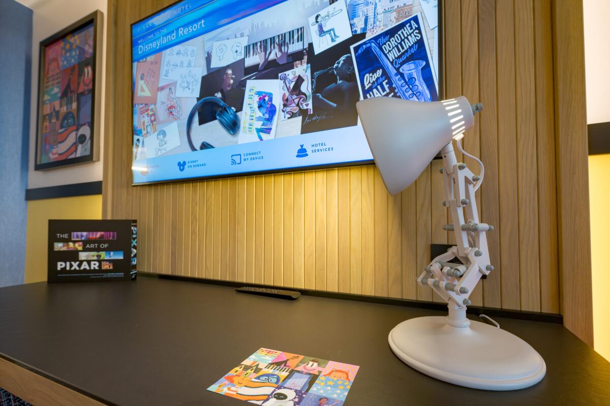 A close-up of lamp and "The Art of Pixar" book.