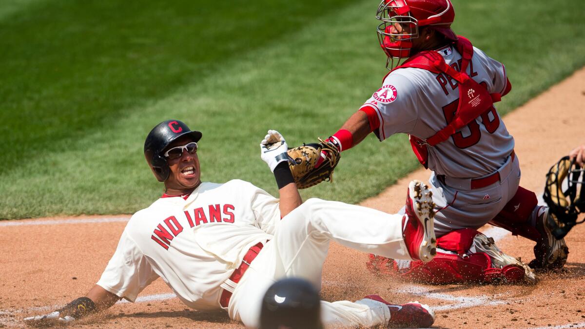 Indians designated hitter Michael Brantley slides safely past the tag attempt of Angels catcher Carlos Perez in the first inning on Aug. 30, 2015.