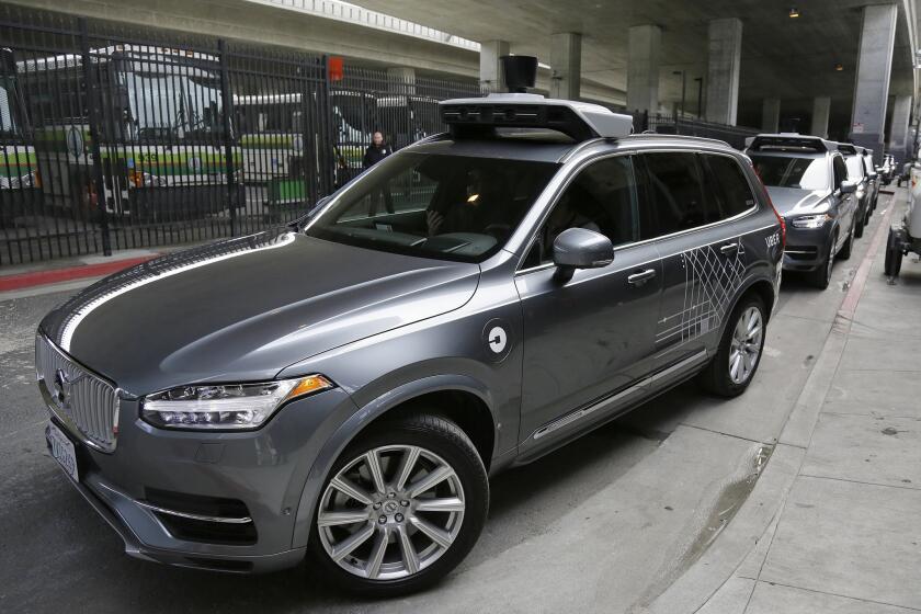 An Uber self-driving car heads out for a test drive in San Francisco. Hours after Uber launched the self-driving service Wednesday, California's Department of Motor Vehicles warned that it was illegal because the cars did not have a special permit.