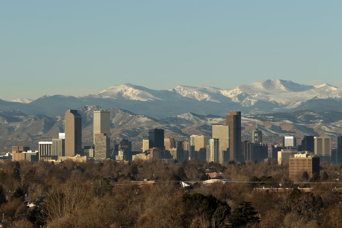 The Rocky Mountains rise beyond the Denver skyline.