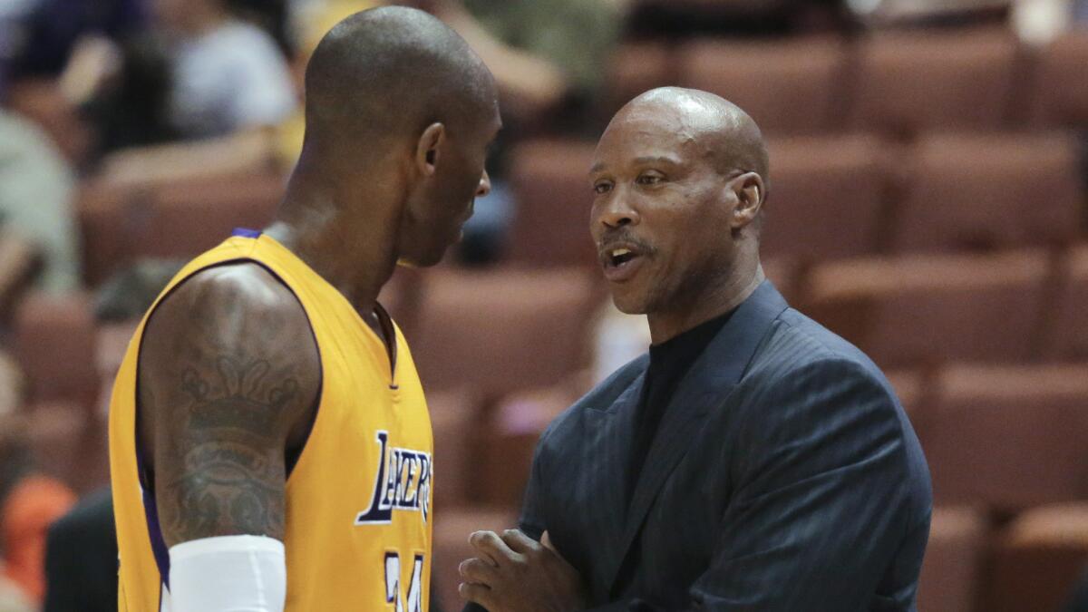 Lakers Coach Byron Scott speaks with Kobe Bryant during a preseason game against the Utah Jazz at Honda Center last month.