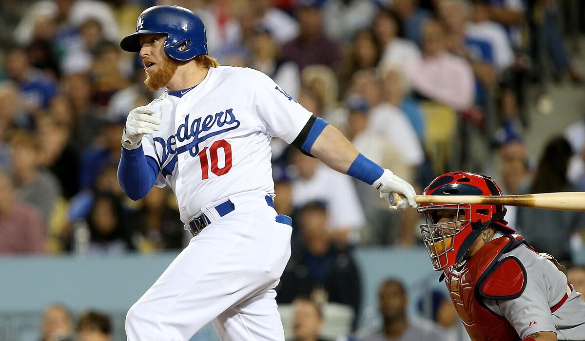 Dodgers pinch-hitter Justin Turner delivers a run-scoring single against the Cardinals in the eighth inning of a game last month at Dodger Stadium.
