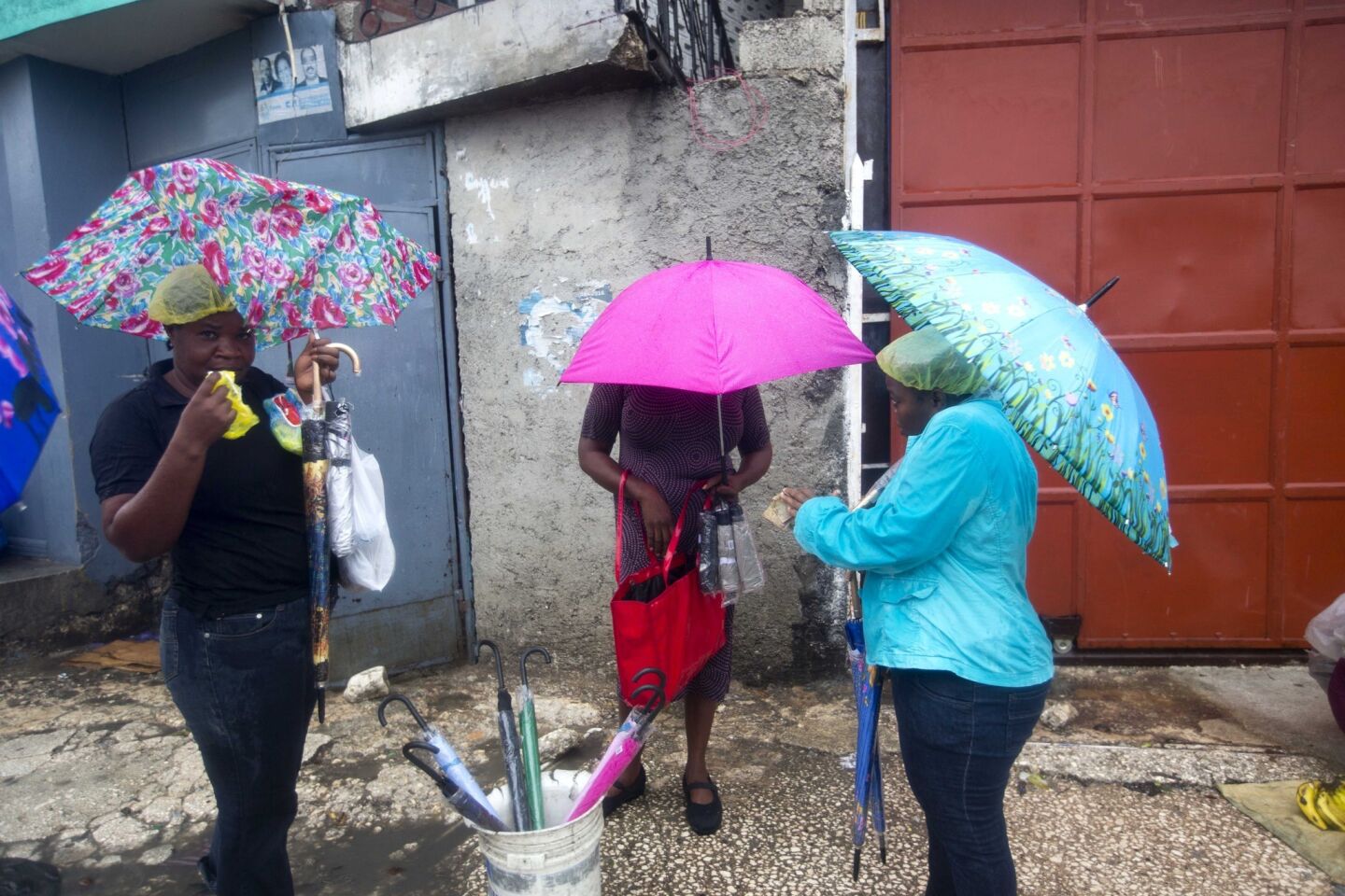 Women sell umbrellas during the arrival of Hurricane Matthew in Port-au-Prince, Haiti.