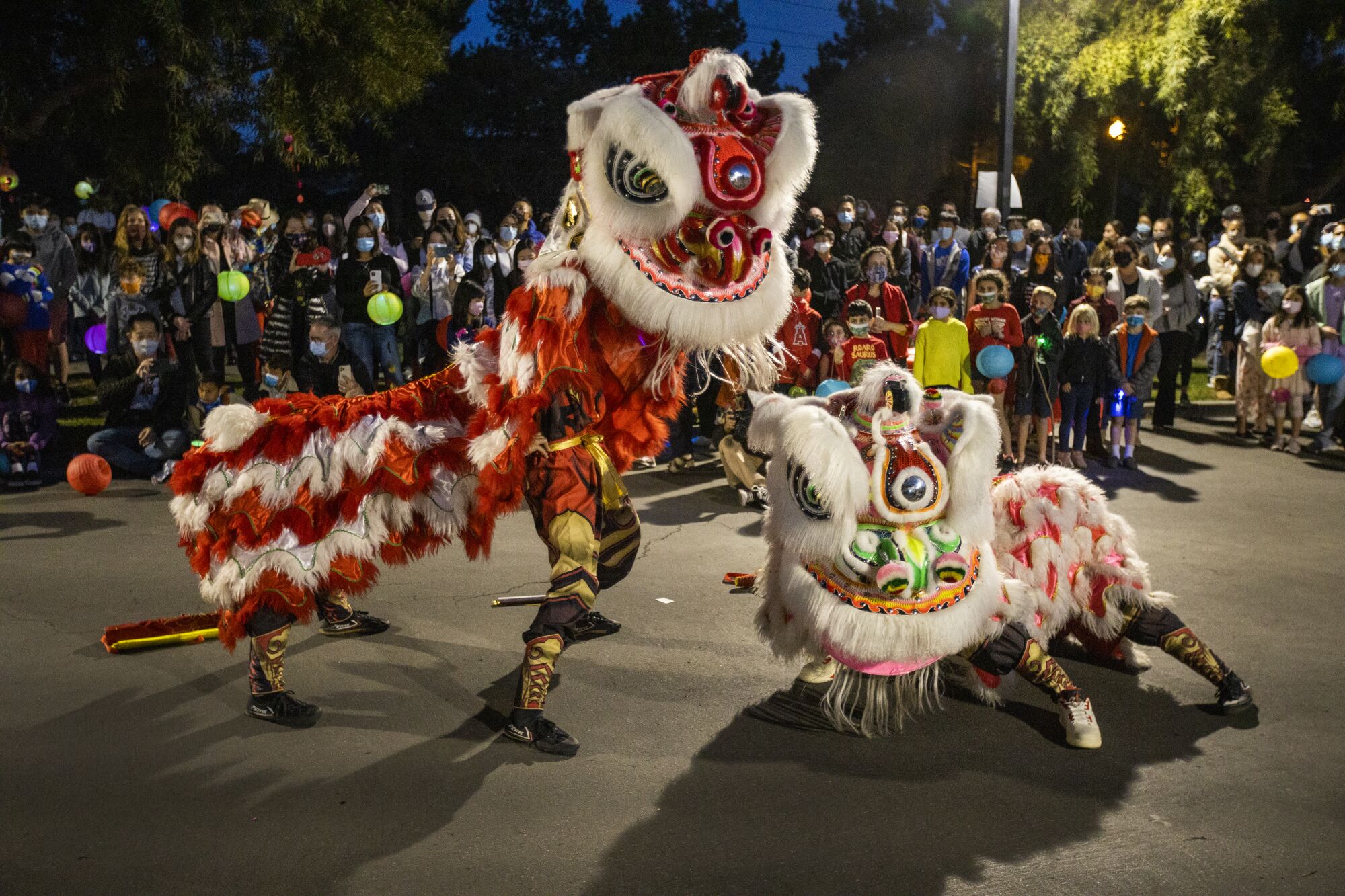 The Qing Wei Lion and Dragon Dance Cultural Troupe performs a lion dance in Ladera Ranch
