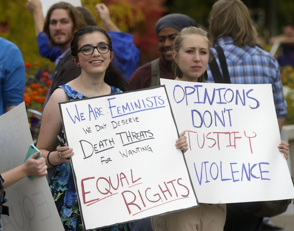 Mikaila Young, left, and Shannon Rigby protest at Utah State University after feminist speaker Anita Sarkeesian canceled an appearance when she learned that audience members could bring concealed firearms to the event despite an anonymous threat against her.