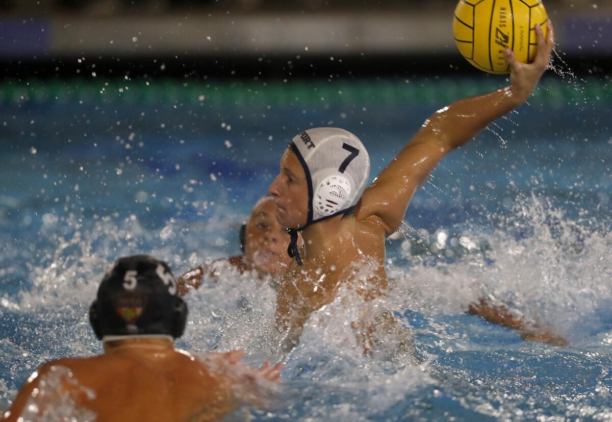 Newport Harbor's Mason Hunt (7) scores against Huntington Beach during the first half of a Surf League match in Newport Beach on Wednesday.