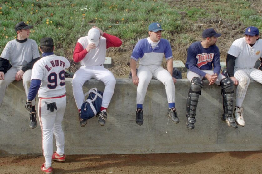 Amateur and former professional baseball players attend open tryouts for the California Angels in Fullerton in January 1995.