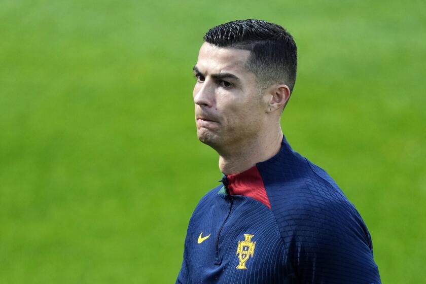 Cristiano Ronaldo walks on the pitch during a Portugal soccer team training in Oeiras