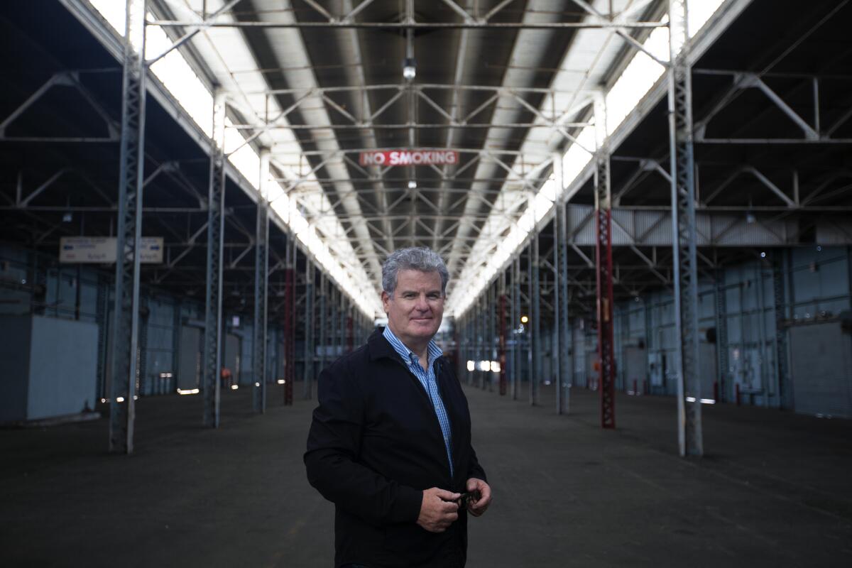 A man stands in a warehouse