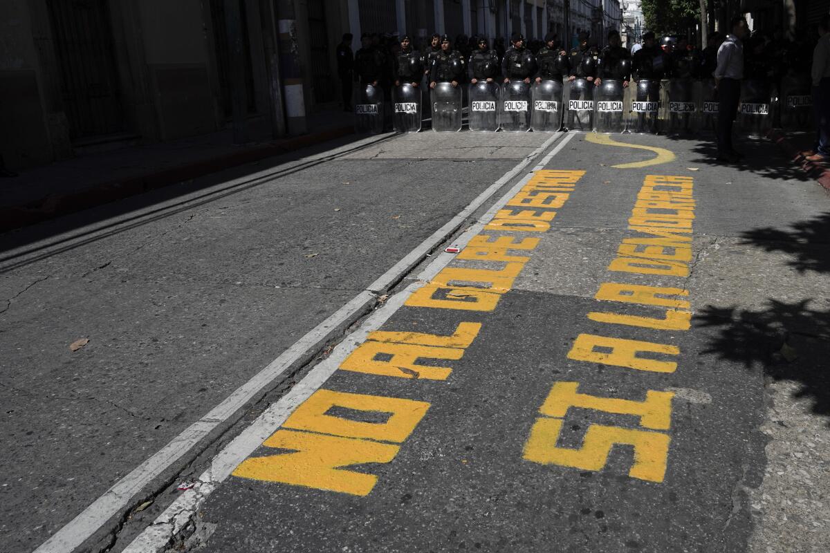 ARCHIVO - Un mensaje escrito se ve en el asfalto en defensa de la democracia, 