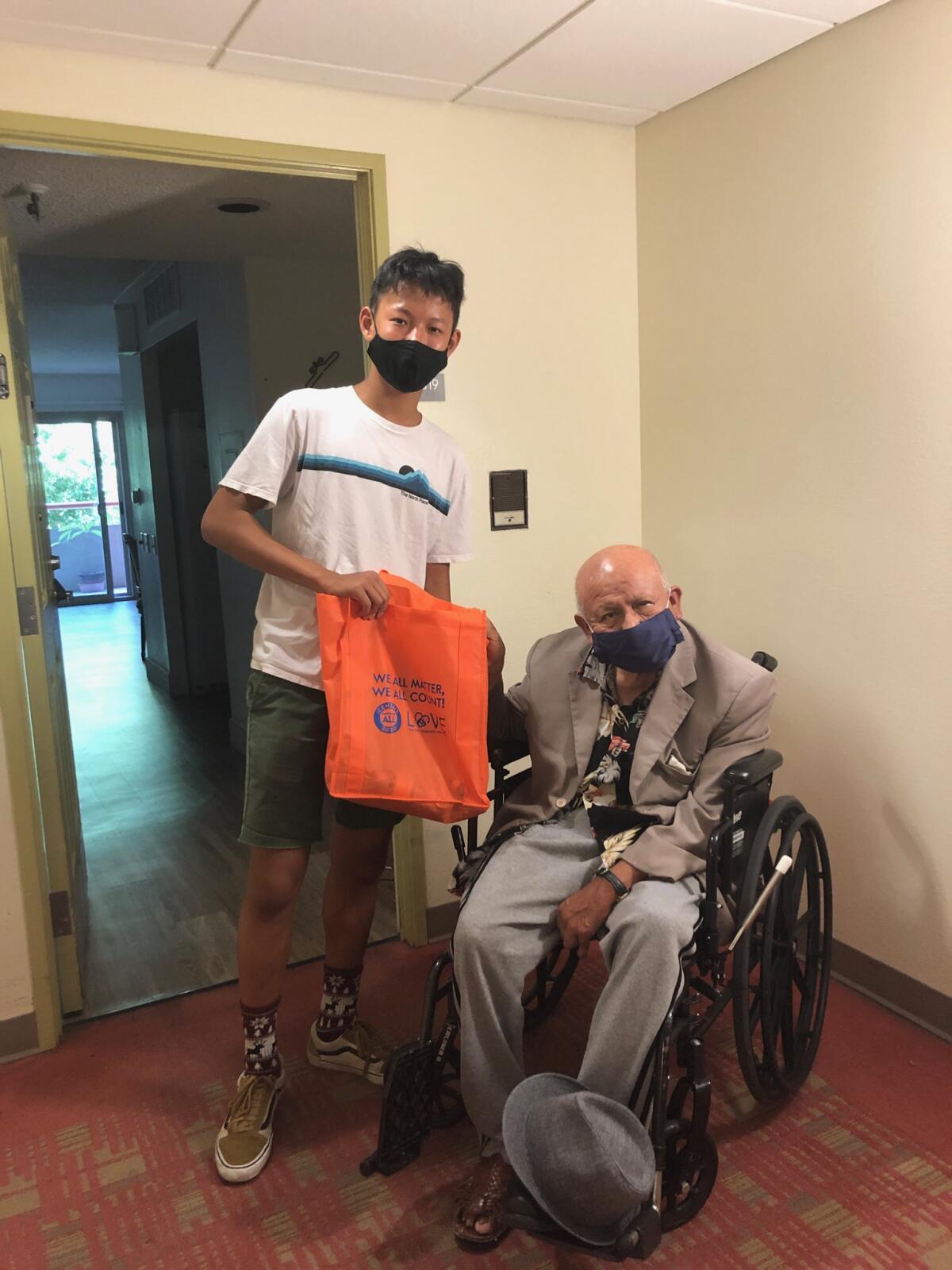 A community volunteer with AASCSC delivers gifts to a senior father.