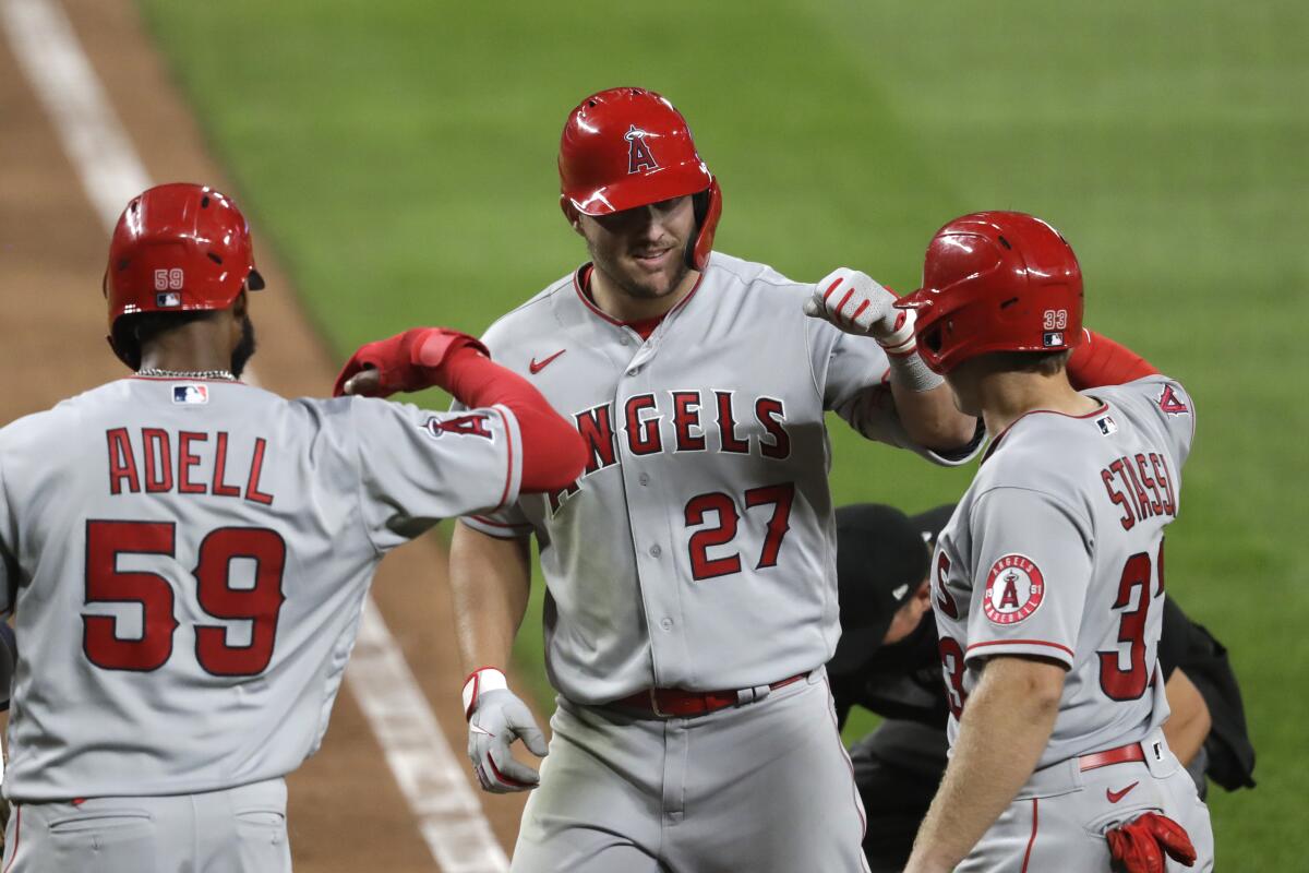 Angels' Mike Trout is met at home by Jo Adell and Max Stassi.