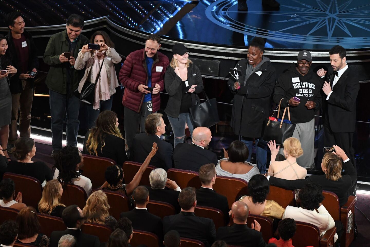 Surprised tourists brought to the Oscars chat with celebrities in the front row.