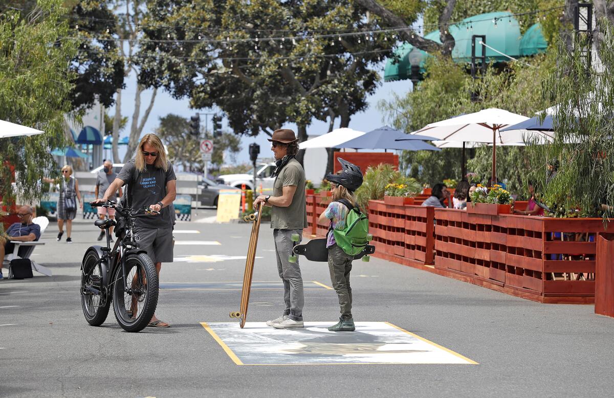 A few locals gather on the Promenade on Forest in downtown Laguna Beach, which opened to the public in June 2020.