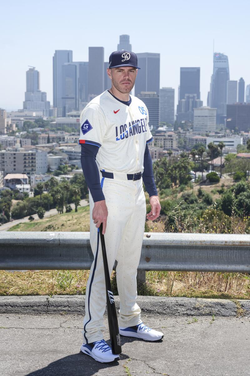 Dodgers first baseman wears the team's new city connect uniform while standing in front of the downtown Los Angeles skyline.