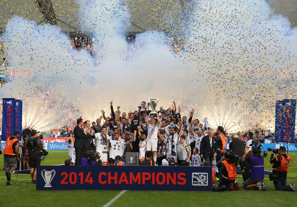 Galaxy forward Robbie Keane hoists the Philip F. Anschutz Trophy after the Galaxy won the 2014 MLS Cup in December.