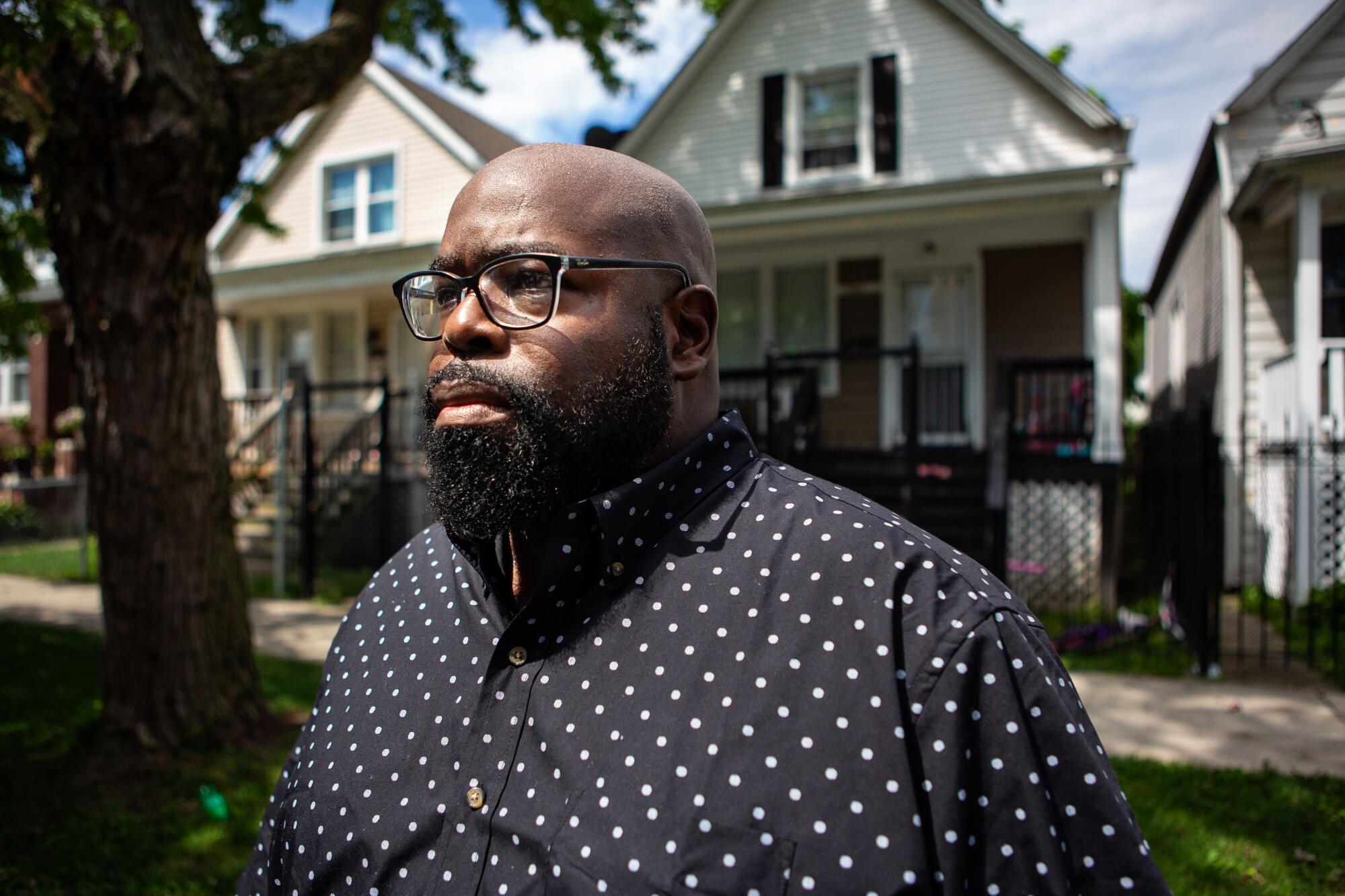 Donovan Price of Chicago stands in front of the home where 13-year-old Deon Williams was shoot and killed.