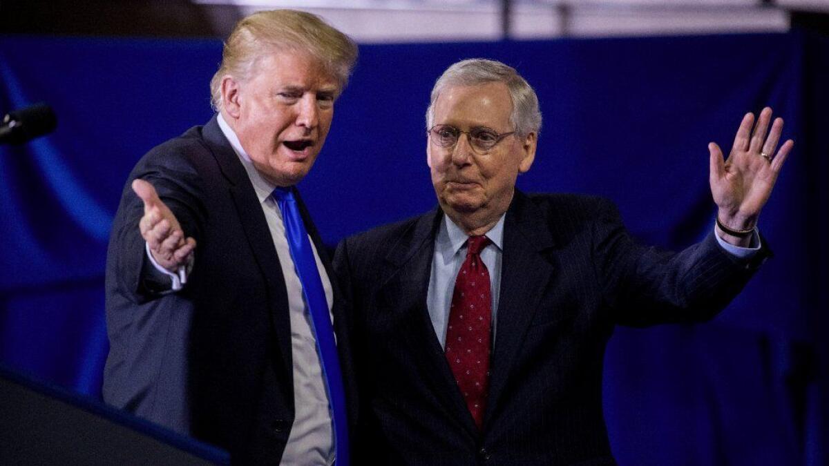 President Trump and Senate Majority Leader Mitch McConnell stand on stage during a campaign rally in Richmond, Ky., on Oct. 13.