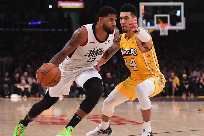 LOS ANGELES, CA - DECEMBER 25: Danny Green #14 of the Los Angeles Lakers defends Paul George #13 of the Los Angeles Clippers as he drives to the basket in the first half of the game at Staples Center on December 25, 2019 in Los Angeles, California. NOTE TO USER: User expressly acknowledges and agrees that, by downloading and/or using this Photograph, user is consenting to the terms and conditions of the Getty Images License Agreement. (Photo by Jayne Kamin-Oncea/Getty Images)