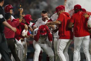 Los Angeles Angels surround Taylor Ward (3) after the Angels defeated the Houston Astros.
