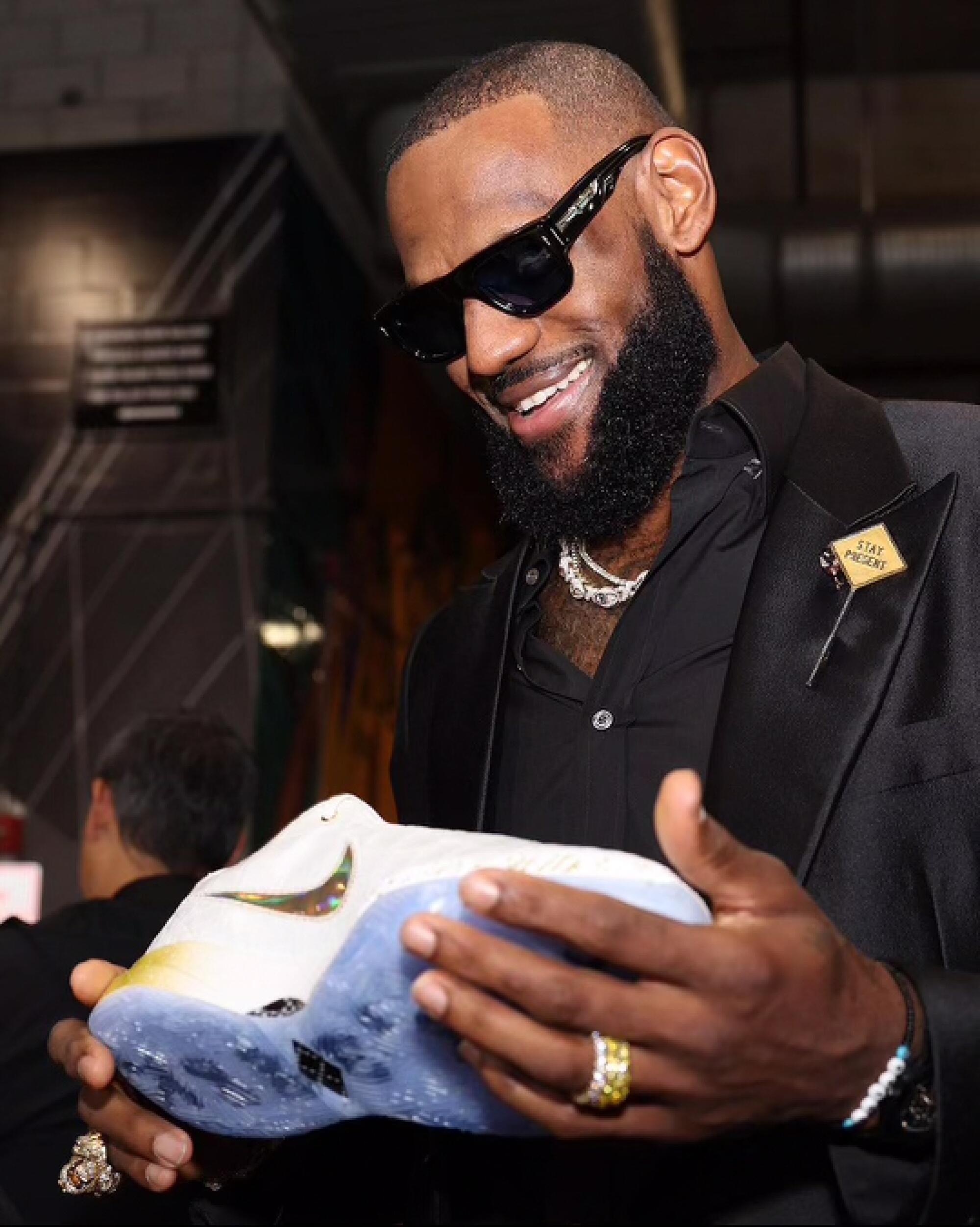 LeBron James holds a custom sneaker.