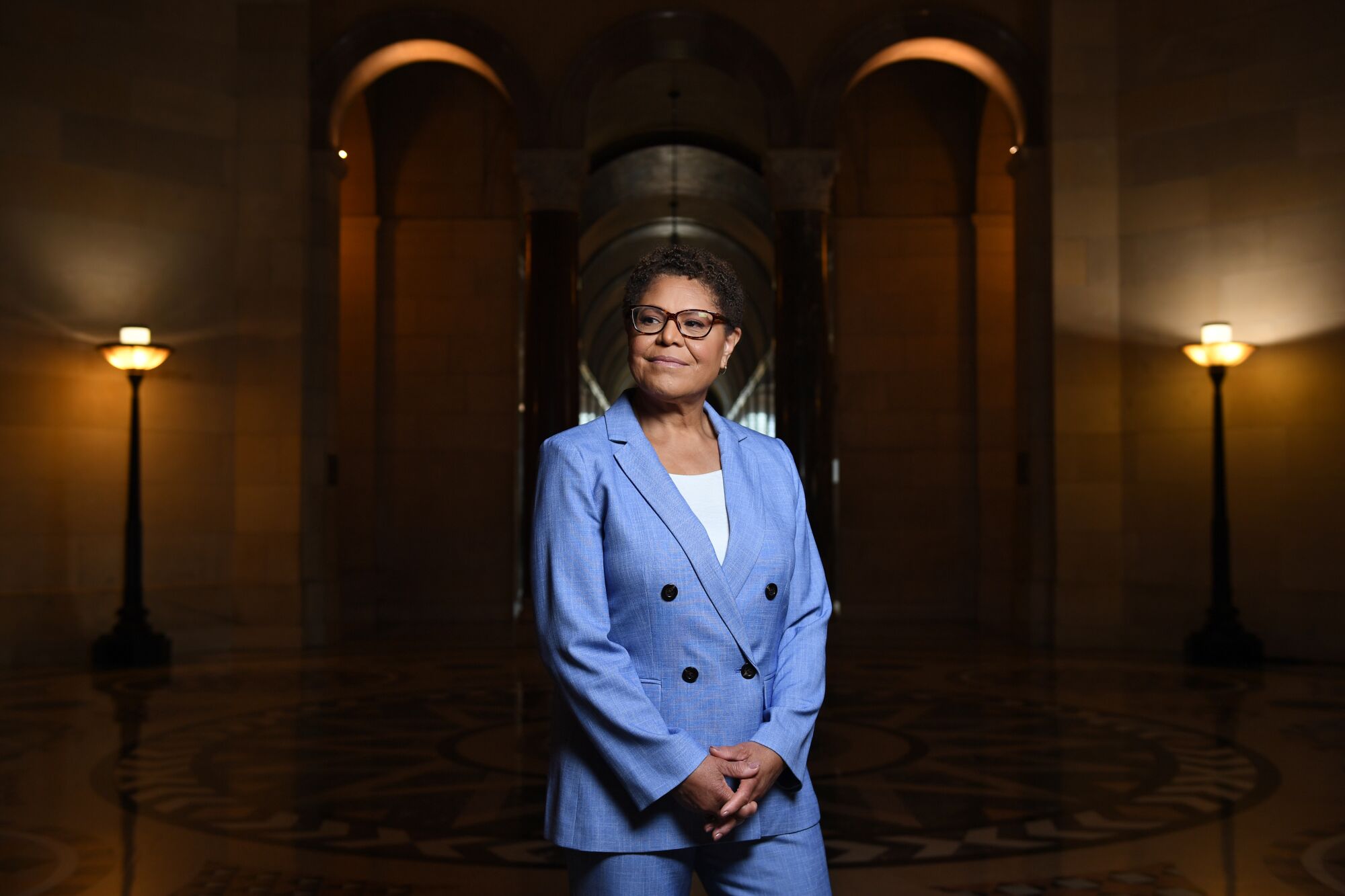 A portrait of Karen Bass in a blue pantsuit.