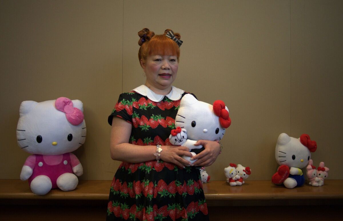 Yuko Yamaguchi, designer of Japanese cartoon and global mega-brand Hello Kitty, poses with various dolls in Hong Kong in July. She will appear on a panel at the Hello Kitty Con 2014 in Los Angeles.