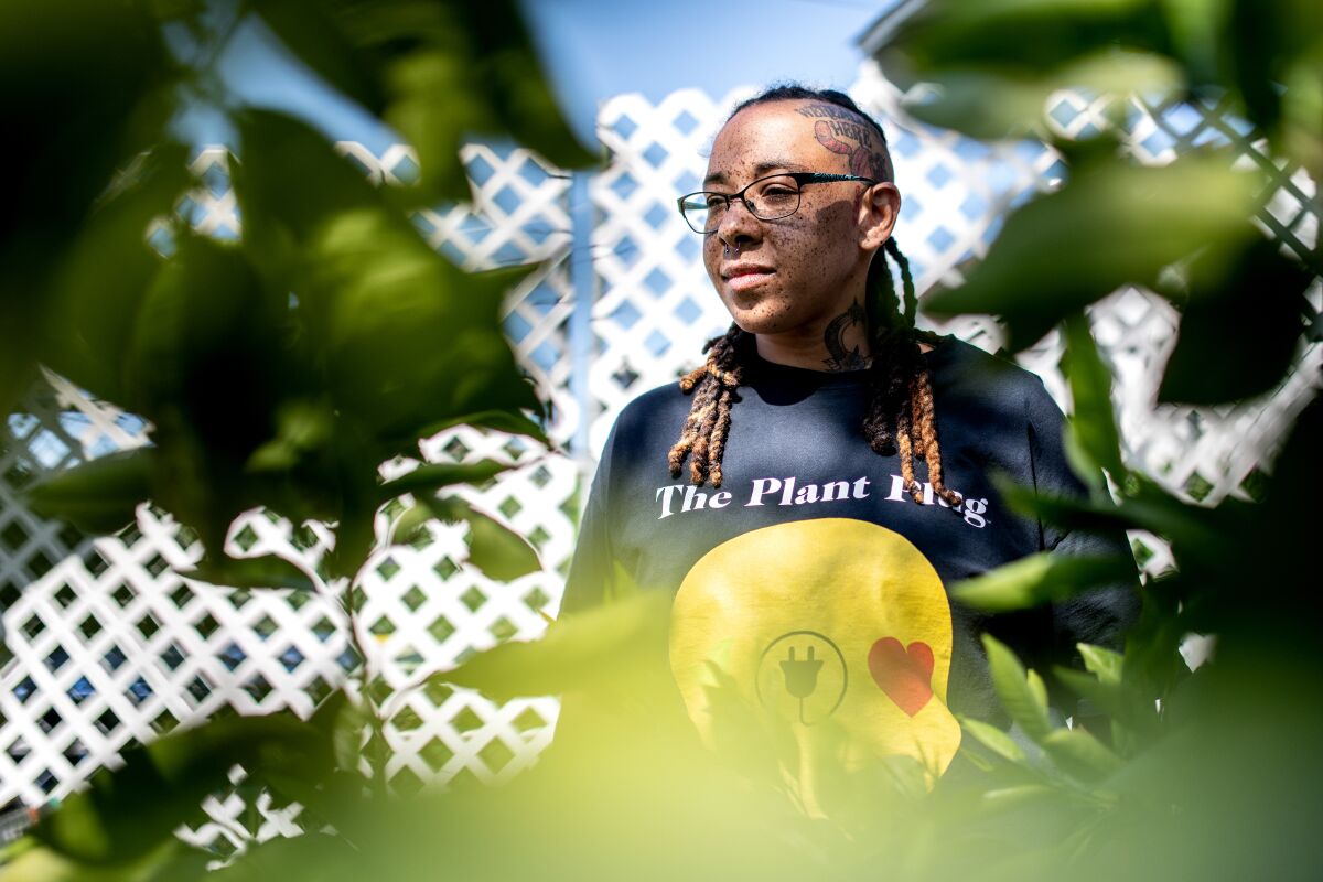 A woman is surrounded by plants