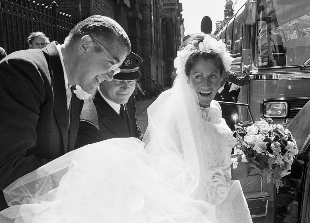 Peter O'Malley helps his bride, Annette, into a car after their wedding in 1971.