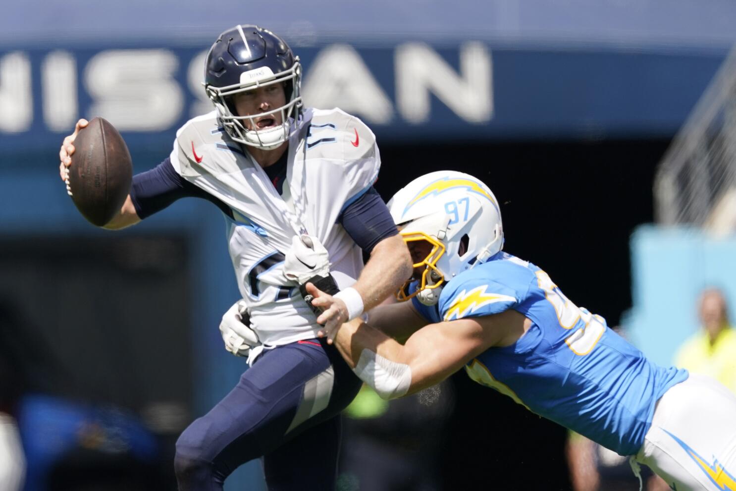 Tennessee Titans running back Derrick Henry (22) is stopped by Los Angeles  Chargers linebacker Nick Niemann (31) and safety Alohi Gilman during  overtime of an NFL football game Sunday, Sept. 17, 2023