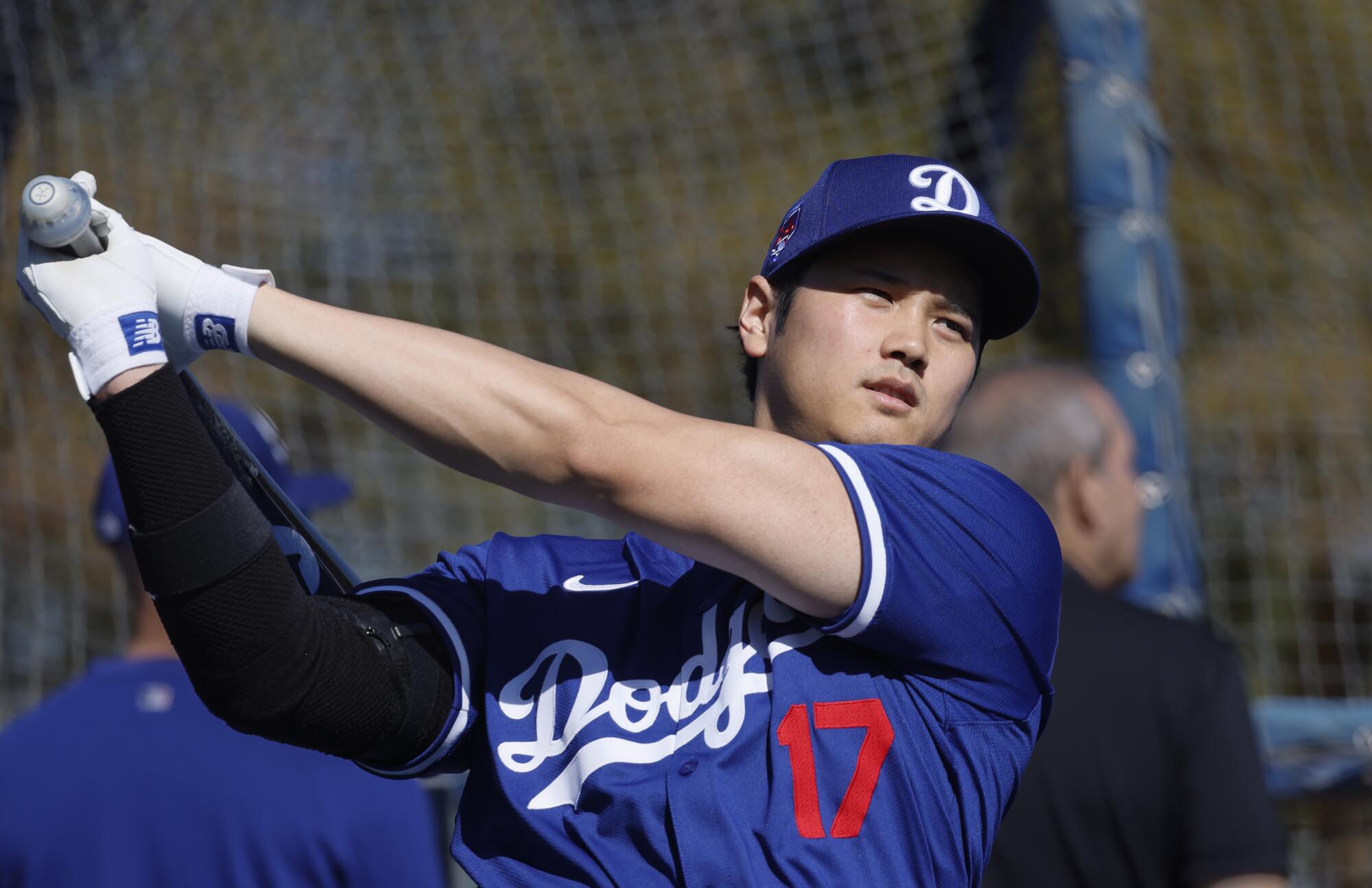 Shohei Ohtani, Şubat ayındaki bahar antrenmanı sırasında biraz vuruş yapmadan önce vuruş kafesinin yanında ısınıyor.