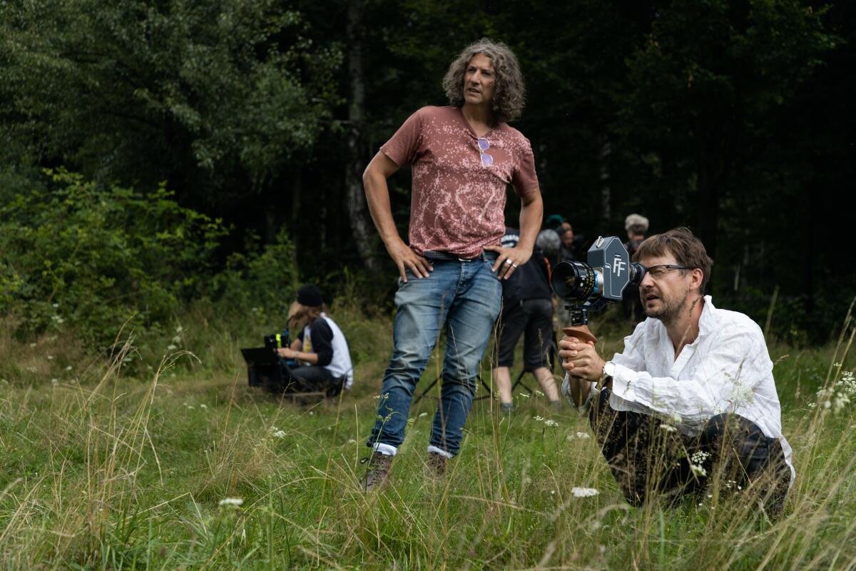 A small film crew captures a shot outdoors.
