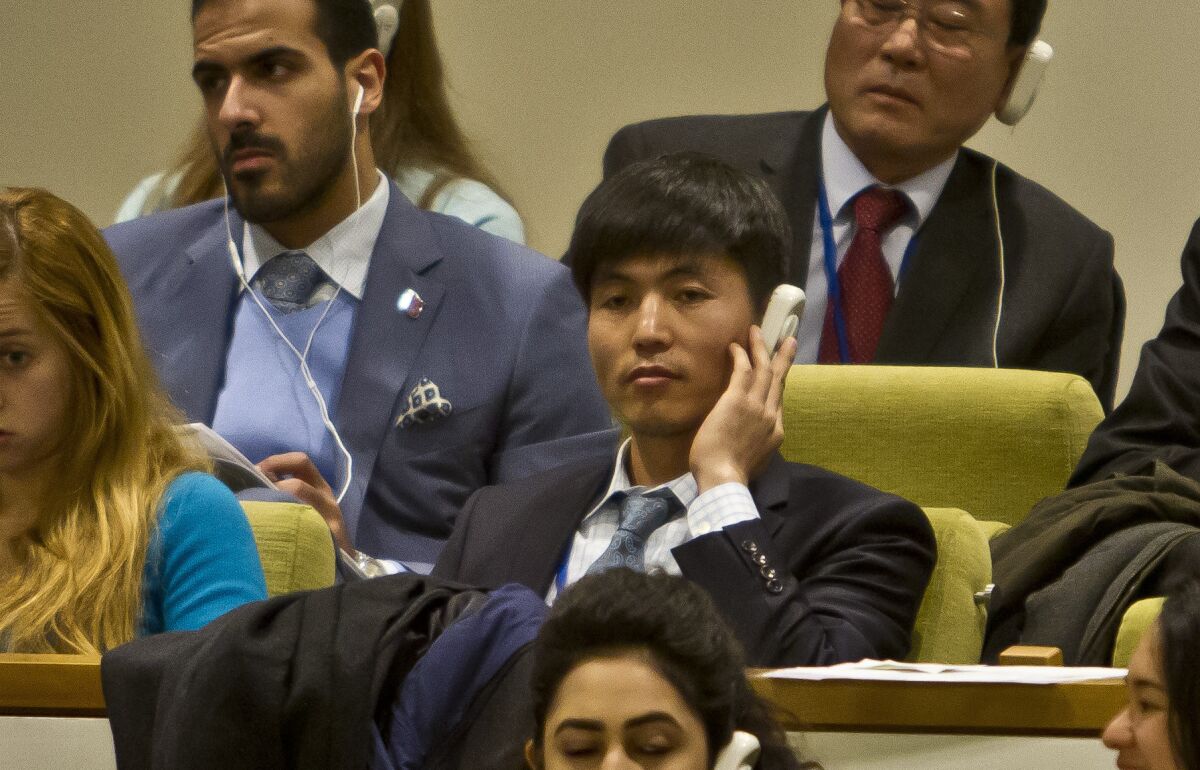 North Korean defector Shin Dong-hyuk, center, listens Tuesday to translation of the U.N. General Assembly human rights committee discussion of a move to censure Pyongyang for alleged crimes against humanity.