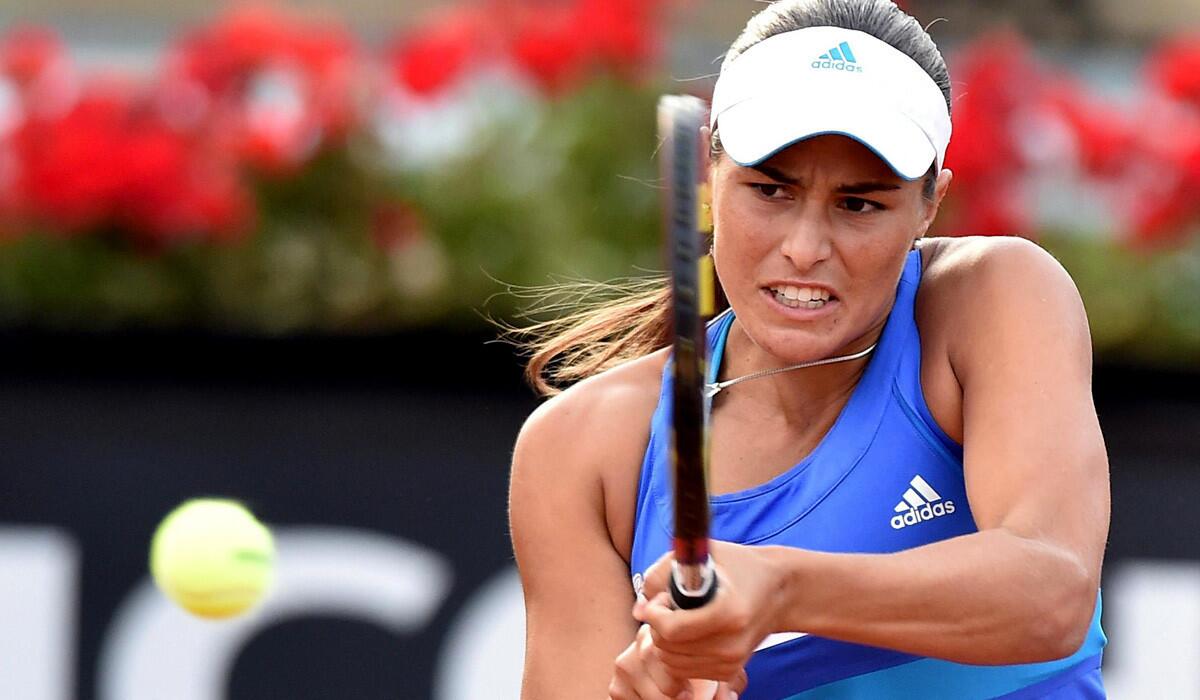 Monica Puig strikes a backhanded shot against Maria Sharapova in the Italian Open last week.