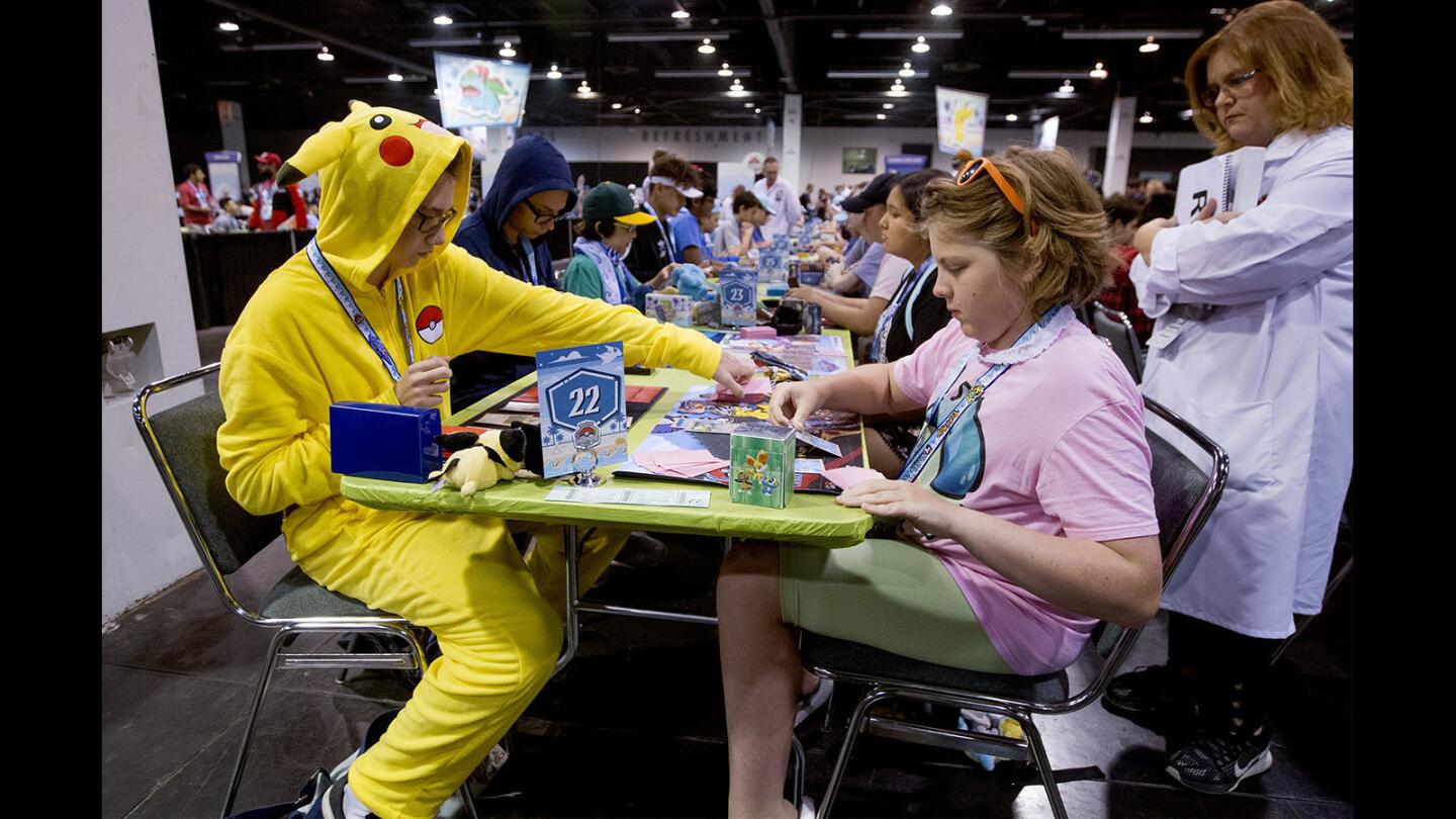 Trading card seniors Emery Taylor, left, competes against Piper Lepine during day one of the 2017 Pokémon World Championships at the Anaheim Convention Center in Anaheim on Friday. (Kevin Chang/ Times OC)